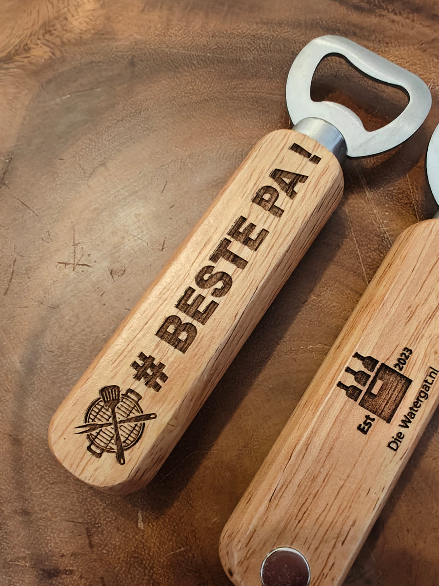 Wooden bottle openers with engraved text on a wooden surface