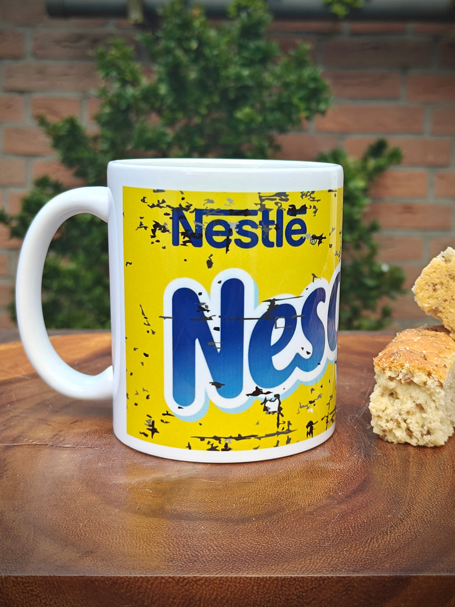 Nesquick Mug with a cartoon character design on a wooden surface with Rusks.
