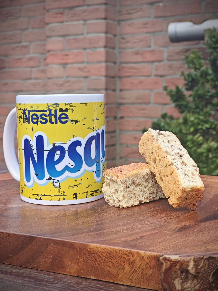 Nesquick Mug with a cartoon character design on a wooden surface with Rusks.