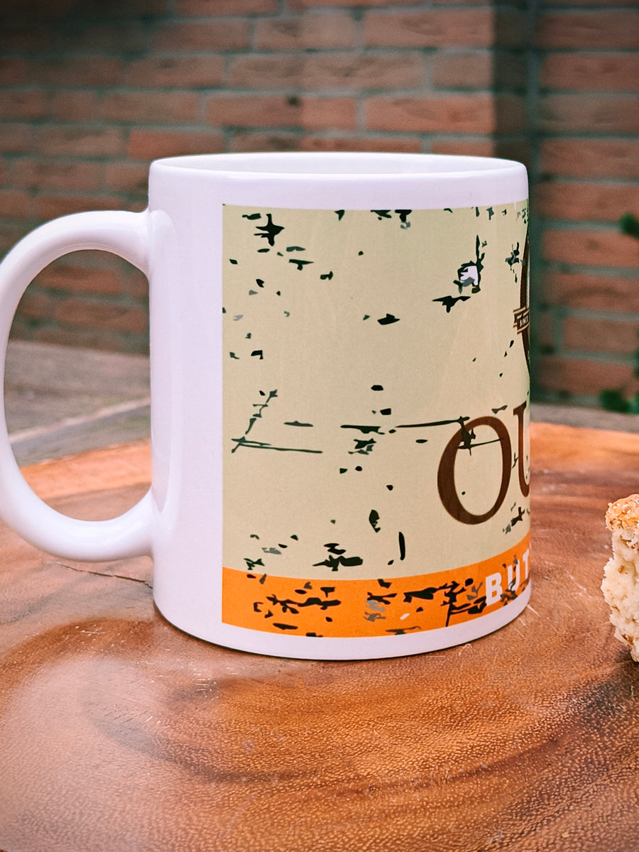 Ouma Buttermilk Rusk Mug on a wooden surface with two Rusks.