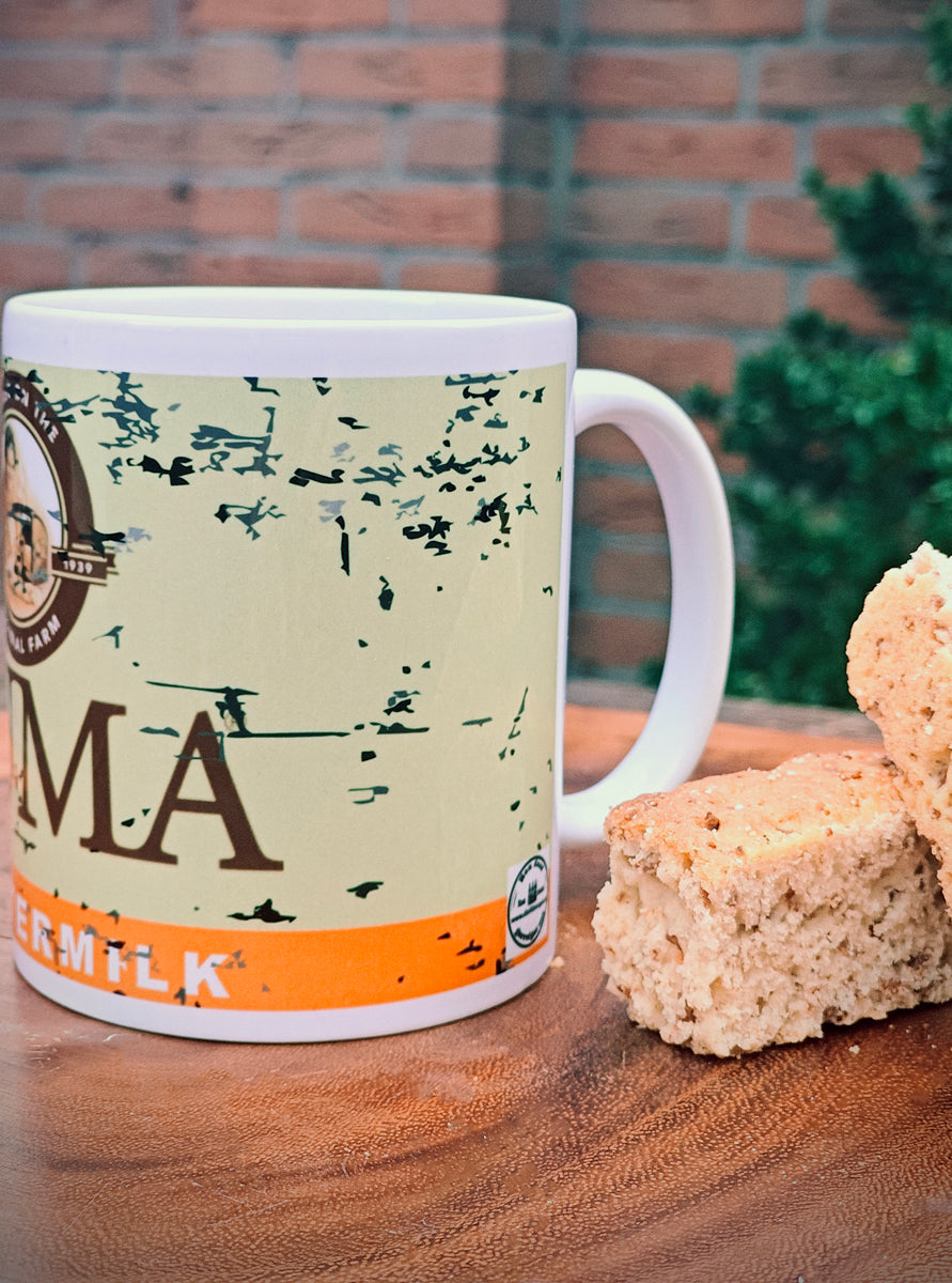 Ouma Buttermilk Rusk Mug on a wooden surface with two Rusks.